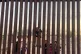 Children play by the fence on the Mexican side of the US-Mex