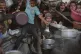 Palestinians struggle to get donated food at a community kitchen in Gaza City, northern Gaza Strip,, July 14, 2025