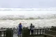 People watch as strong waves batter Basco, Batanes province, northern Philippines as Typhoon Ragasa affects the area, September 22, 2025