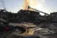 Rescue workers put out a fire at a building destroyed during a Russian strike in Zaporizhzhia, Ukraine, September 22, 2025