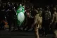A protester dressed in a costume watches as Department of Homeland Security officers detain a protester outside a U.S. Immigration and Customs Enforcement facility on Thursday, Oct. 2, 2025, in Portland, Ore