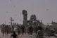 Palestinians collect leaflets dropped by an Israeli drone warning people to stay away from the so-called yellow line in Khan Younis, in the southern Gaza Strip, October 20, 2025