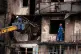 Firefighters work at a destroyed apartment building after a Russian drone attack in Kyiv, Ukraine, October 26, 2025