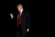 President Donald Trump is illuminated by a camera flash as he walks across the South Lawn of the White House, Sunday, Nov. 2, 2025, in Washington, after returning from a trip to Florida