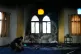 A video journalist works by a burnt indoor section of a mosque that was torched and defaced by Israeli settlers overnight, in the West Bank town of Deir Istiya, November 13, 2025