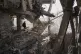 Palestinians inspect the ruins a day after an Israeli strike on a building in Gaza City, November 20, 2025