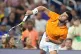 Carlos Alcaraz follows through on a serve to Joao Fonseca during the Miami Tennis Invitational tournament, in Miami, December 8, 2025