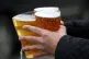 A fan carrying three pints of alcohol