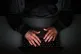 A laptop user with their hood up