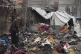 Fatima Abu al-Bayd inspects what remains of her mother's tent after her mother, Amal Abu Al-Khair, and grandchild, Saud, were killed when it caught fire overnight at the Yarmouk displacement camp in Gaza City, January 2, 2026