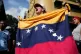 Government supporters rally in Caracas, Venezuela, January 3, 2026, after President Donald Trump announced that U.S. forces had captured Venezuelan President Nicolás Maduro and his wife