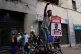 A government supporter holds a banner for President Nicolas Maduro during a protest demanding his release, after U.S. forces captured and flew him to the United States, in Caracas, Venezuela, January 4, 2026