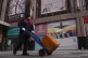 A deliver worker transfers the merchandise outside the Ritan International Trade Center in Beijing, January 19, 2026