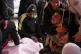 Palestinians mourn over the body of Mohammed Al-Rajoudi, after he was killed by Israeli fire, during his funeral at Al-Aqsa Hospital in Deir al-Balah, central Gaza Strip, January 21, 2026