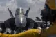 This handout photograph from the U.S. Navy shows Aviation Boatswain's Mate 2nd Class Michael Cordova directing an F/A-18F Super Hornet on the flight deck of the Nimitz-class aircraft carrier USS Abraham Lincoln in the Indian Ocean on Jan. 23, 2026
