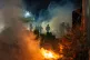 Federal immigration officers are seen outside Bishop Whipple Federal Building after tear gas was deployed, January 12, 2026, in Minneapolis