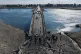 People cross the damaged Al-Rashid Bridge on foot, destroyed by retreating Syrian Democratic Forces (SDF) troops, a day after Syrian government troops took control of the area on the outskirts of Raqqa, northeastern Syria, January 19, 2026