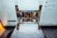 The Grok app on an iPhone, against the backdrop of search results displayed on the social media platform X (formerly Twitter) on a laptop, in London