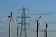A view of the Little Cheyne Court Wind Farm amongst existing electricity pylons on the Romney Marsh in Kent
