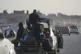 Palestinians travel on a cart attached to a car along the coastal road in Zawaida, central Gaza Strip, February 11, 2026
