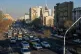 Vehicles drive past the Saint Sarkis church and a painting of the late Iranian revolutionary founder Ayatollah Khomeini in downtown Tehran, Iran, February 25, 2026