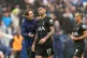 Tottenham Hotspur manager Thomas Frank (left) speaks with Cristian Romero on the pitch after the Premier League match, Brighton, September 20, 2025