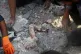 The arm of a deceased person is seen protruding from the rubble as rescue workers and residents search in the aftermath of an Israeli-US strike on a girls' elementary school in Minab, Iran, February 28, 2026