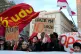 Supporters of the ‘No’ vote celebrate the outcome of a constitutional referendum that will cancel a justice reform approved by Parliament, in Rome, March 23, 2026. Placard reads ‘No, thank you’