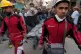Members of the Iranian Red Crescent Society and other people carry a black sack containing the body of a victim who was killed after a residential building hit by a US-Israeli strike in Tehran, March 27, 2026