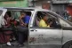 Passengers ride in a shared taxi as it makes its way through Port-au-Prince, Haiti, March 25, 2026