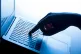 A woman's hand pressing a key of a laptop keyboard