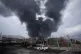 A thick plume of smoke rises from an oil storage facility hit by a US-Israeli strike late Saturday in Tehran, Iran, March 8, 2026
