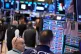 People work on the floor at the New York Stock Exchange in New York, March 31, 2026