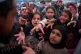 Displaced families extend their hands while waiting for donated food beside the tents they use as shelters after fleeing Israeli bombardment in southern Lebanon, in Beirut, Lebanon, April 9, 2026