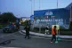 A worker cleans the street as police officers walks towards their vehicle outside a media center close to Serena Hotel, the venue for the U.S. Iran officials meeting, in Islamabad, Pakistan, April 12, 2026