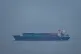 A cargo ship sails in the Persian Gulf towards Dubai port as seen from Ajman, United Arab Emirates, April 14, 2026