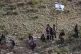 Palestinian students walk to school along a fence separating their village from a nearby illegal Israeli settlement of Carmel, which forces them to take an alternative route nearly twice as long, near the West Bank village of Umm al-Khair, April 14, 2026