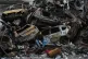 A man sits next to charred cars and wreckage where a building was destroyed by an Israeli air strike the previous Wednesday, in central Beirut, Lebanon, April 14, 2026