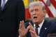 President Donald Trump answers questions from reporters after signing an executive order in the Oval Office of the White House, March 31, 2026, in Washington