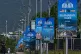 Workers walk past billboards near the Serena Hotel ahead of the second round of negotiations between the U.S. and Iran, in Islamabad, Pakistan, April 20, 2026