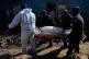 Police officers carry the body of a person on a stretcher after a mass shooting at an informal settlement in the Cleveland suburb of Johannesburg, South Africa, June 10, 2026