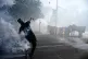 A protester throws a flare during a demonstration in Geneva, Switzerland, June 14, 2026