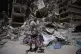 Barber Wissam Srour, 41, holds his daughter's bicycle recovered from his barbershop as he searches for belongings in the rubble of the shop, damaged in an Israeli strike, in the southern port city of Tyre, Lebanon, June 19, 2026
