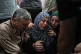 Najah Wishah, center, mourns over the body of her son, Ahmed Wishah, an Al Jazeera cameraman who was killed in an Israeli airstrike, during his funeral at Al-Aqsa Hospital in Deir al-Balah, central Gaza Strip, June 21, 2026
