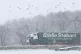 An Eddie Stobart lorry passes through heavy snow on the A66 in the North Pennines