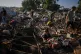 Palestinians collect food from the wreckage of their tents following an Israeli airstrike in Khan Younis, Gaza Strip, June 30, 2026