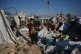 Oday Abu Khater, 10, carries his cat from his tent, which was destroyed by an Israeli air strike that targeted a camp for displaced people in Khan Younis, Gaza Strip, June 30, 2026