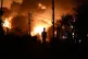 A man with a respirator mask on his head is silhouetted during a wildfire on the outskirts of the northern city of Thessaloniki, Greece, July 5, 2026