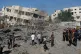 People gather around the site of an Israeli military drone strike on a blacksmith shop in Gaza City's Sabra neighbourhood killing at least four Palestinians and wounded another, July 12, 2026