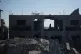 A Palestinian woman inspects a destroyed building following an Israeli air strike in Deir al-Balah, central Gaza Strip, July 19, 2026